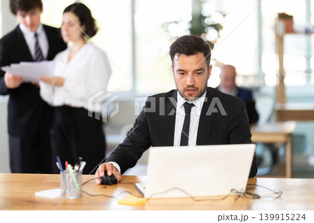 Business adult man concentrating on tasks while working at computer in office 139915224