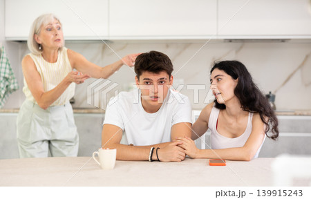 Elderly woman swears at young married couple 139915243