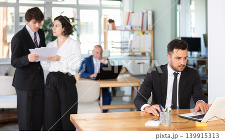 Office employee working on a laptop 139915313