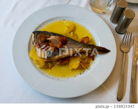 Dorado fish with lemon and potatoes served at plate close up 139915347