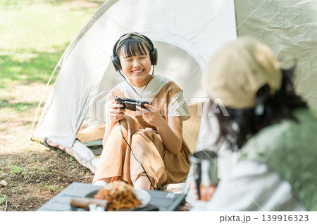 ファミリーキャンプでゲームをする子供と母親（家族・旅行） 139916323
