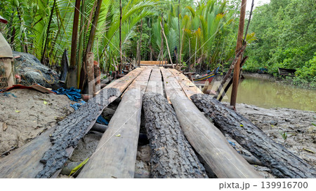 Traditional Wooden Boardwalk Wooden Bridge in Mangrove Forest Creek 139916700