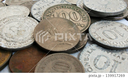 Close up of Indonesian antique coin collection with classic 50 Rupiah and 100 Rupiah coins. Close up of Indonesian antique coin collection with classic 50 Rupiah and 100 Rupiah coins. 139917269