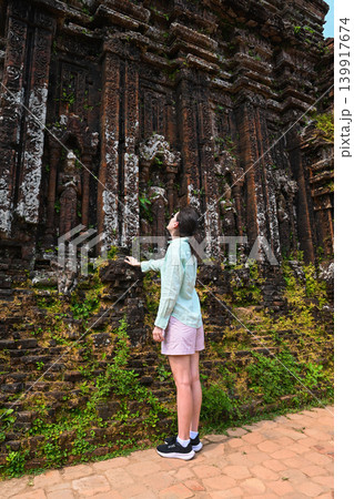 A 30 year old Russian woman tourist explores the ancient ruins of My Son sanctuary of Champa civilization near Da Nang in Quang Nam province Vietnam A 30 year old Russian woman tourist explores the ancient ruins of My Son sanctuary of Champa civilization near Da Nang in Quang Nam province Vietnam 139917674