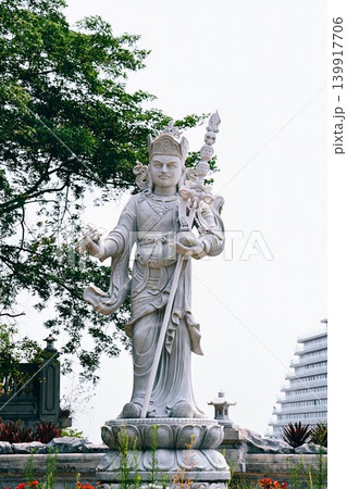 White marble statue of a Buddhist guardian deity or warrior standing on a lotus pedestal at Marble Mountains in Da Nang Vietnam White marble statue of a Buddhist guardian deity or warrior standing on a lotus pedestal at Marble Mountains in Da Nang Vietnam 139917706