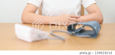 woman checking Blood pressure by Blood pressure monitor with Cuff. Systolic, SYS, Diastolic, DIA, Pulse, Hypertension, Hypotension, Heart rate, Cardiovascular Disease and May World hypertension day woman checking Blood pressure by Blood pressure monitor with Cuff. Systolic, SYS, Diastolic, DIA, Pulse, Hypertension, Hypotension, Heart rate, Cardiovascular Disease and May World hypertension day 139919218