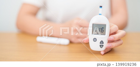 Hand checking Diabetes or Blood glucose self testing by digital blood glucose meter with lancet pen. high blood sugar level, World Diabetes Day, Glycemia, Hypoglycemia, Hyperglycemia and insulin Hand checking Diabetes or Blood glucose self testing by digital blood glucose meter with lancet pen. high blood sugar level, World Diabetes Day, Glycemia, Hypoglycemia, Hyperglycemia and insulin 139919236