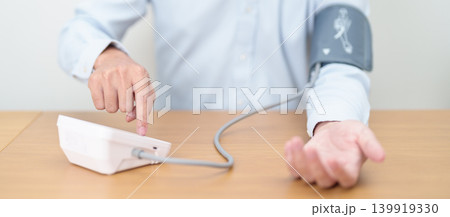 Man checking Blood pressure by Blood pressure monitor with Cuff. Systolic, SYS, Diastolic, DIA, Pulse, Hypertension, Hypotension, Heart rate, Cardiovascular Disease and May World hypertension day Man checking Blood pressure by Blood pressure monitor with Cuff. Systolic, SYS, Diastolic, DIA, Pulse, Hypertension, Hypotension, Heart rate, Cardiovascular Disease and May World hypertension day 139919330