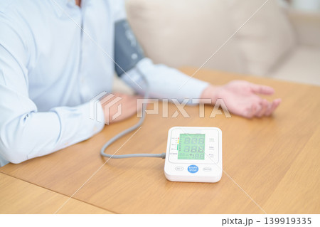 Man checking Blood pressure by Blood pressure monitor with Cuff. Systolic, SYS, Diastolic, DIA, Pulse, Hypertension, Hypotension, Heart rate, Cardiovascular Disease and May World hypertension day Man checking Blood pressure by Blood pressure monitor with Cuff. Systolic, SYS, Diastolic, DIA, Pulse, Hypertension, Hypotension, Heart rate, Cardiovascular Disease and May World hypertension day 139919335