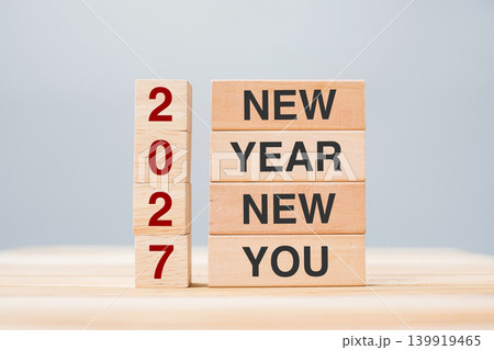 hand holding wooden block with text 2027 NEW YEAR NEW YOU on table background. Resolution, strategy, goal, business and holiday concepts hand holding wooden block with text 2027 NEW YEAR NEW YOU on table background. Resolution, strategy, goal, business and holiday concepts 139919465