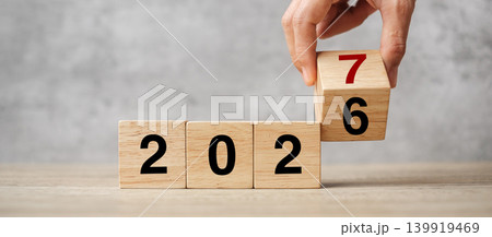 hand flipping block 2026 to 2027  text on table. Resolution, strategy, plan, goal, motivation, reboot, business and New Year holiday concepts 139919469