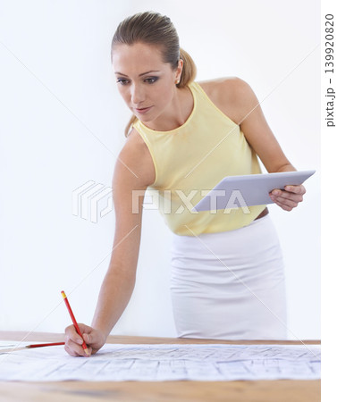 Tablet, architect and woman with blueprint, drawing or sketch at desk in startup office. Technology, engineer and creative designer with pencil on paper for planning construction project for building Tablet, architect and woman with blueprint, drawing or sketch at desk in startup office. Technology, engineer and creative designer with pencil on paper for planning construction project for building 139920820