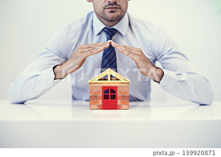Businessman, insurance and home model for mortgage, asset and secure policy premium for house. Male person, broker and confident for idea, office and realtor for protection and liability coverage Businessman, insurance and home model for mortgage, asset and secure policy premium for house. Male person, broker and confident for idea, office and realtor for protection and liability coverage 139920871