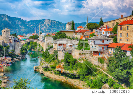 Amazing Skyline of Mostar with the Mostar Bridge, houses and minarets, during sunny day Amazing Skyline of Mostar with the Mostar Bridge, houses and minarets, during sunny day 139922056