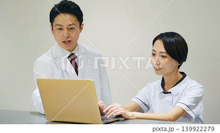 医師と相談する女性医療スタッフ 医師と相談する女性医療スタッフ 139922279
