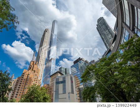 New york, usa august 20,2024. New york city skyscrapers rise above central park's edge under a cloudy sky, highlighting modern skyline, architecture and urban growth 139922449