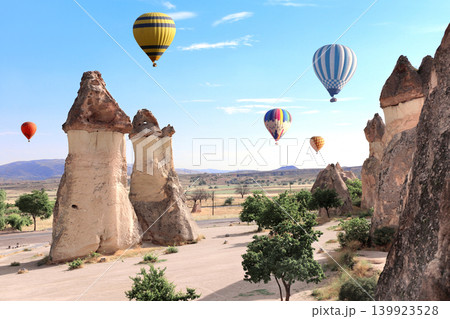 Balloon flight, famous tourist attraction of Cappadocia. Air balloons and Fairy Chimney in Pasabag Valley, Anatolia, Turkey. Popular destination for travellers seeking an adventure and natural beauty 139923528