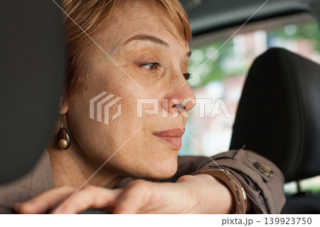 Beautiful senior woman in a car near window Beautiful senior woman in a car near window 139923750
