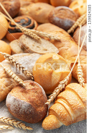 Variety of fresh baked bread, pastry, and wheat ears 139924385