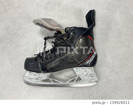 an ice skate on the floor in the locker room an ice skate on the floor in the locker room 139926011