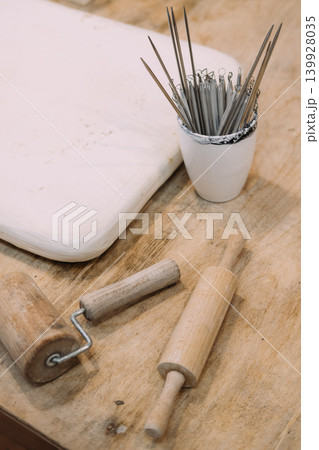 Pottery instruments. Sculpting tools. Ceramic workplace for clay handmade craft wooden rolling pin on artisan table in creative professional studio. 139928035