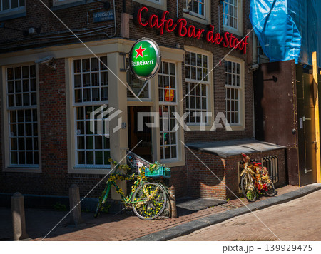 Amsterdam, Netherlands - April 2026: Traditional Dutch cafe bar with Heineken sign and decorated bicycles Amsterdam, Netherlands - April 2026: Traditional Dutch cafe bar with Heineken sign and decorated bicycles 139929475