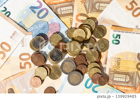 Financial background of Euro money banknotes and coins flat lay Financial background of Euro money banknotes and coins flat lay 139929485