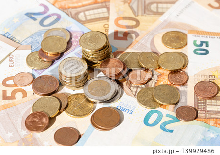 Financial background of a close up of euro banknotes and coins Financial background of a close up of euro banknotes and coins 139929486