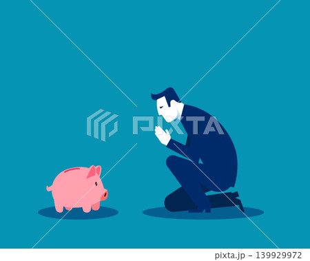 FInancial. A businessman is kneeling and praying to a piggy bank FInancial. A businessman is kneeling and praying to a piggy bank 139929972