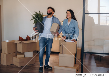 Couple reviewing documents and planning their new home after moving 139930618