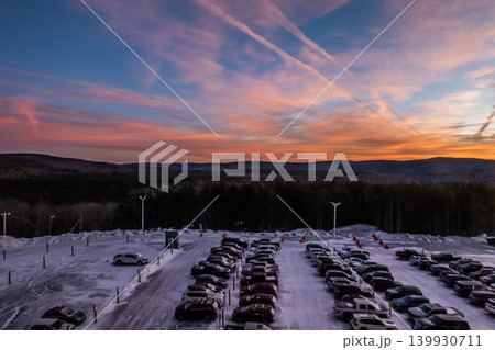 Snowshoe West Virginia Sunset Over Snow Covered Parking Lot with Mountain Landscape Snowshoe West Virginia Sunset Over Snow Covered Parking Lot with Mountain Landscape 139930711