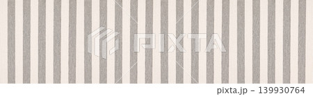 Close up of a woven textile material with thick vertical stripes in neutral grey and beige tones. Close up of a woven textile material with thick vertical stripes in neutral grey and beige tones. 139930764
