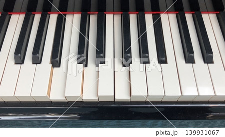 Piano playing music by itself closeup 139931067