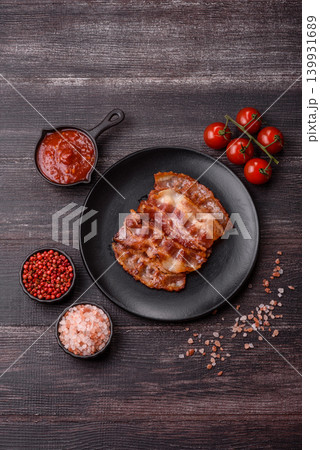 Fried fresh bacon slices with layers of meat or prosciutto with salt and spices. Fried bacon Fried fresh bacon slices with layers of meat or prosciutto with salt and spices. Fried bacon 139931689