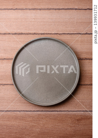 An empty ceramic round plate, kitchen utensils for a dinner table. An empty plate An empty ceramic round plate, kitchen utensils for a dinner table. An empty plate 139931712