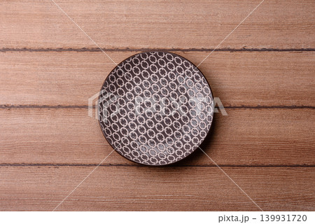 An empty ceramic round plate, kitchen utensils for a dinner table. An empty plate An empty ceramic round plate, kitchen utensils for a dinner table. An empty plate 139931720