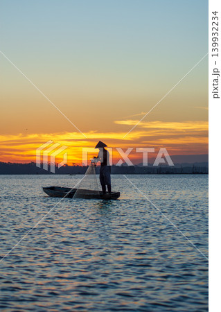 Traditional Fisherman Working on Wooden Boat at Sunset Traditional Fisherman Working on Wooden Boat at Sunset 139932234