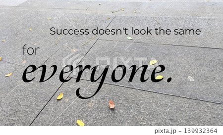 An inspiring quote "Success doesn't look the same for everyone" is written on a textured pavement with scattered dry leaves. The words are set against a subtle, realistic background. 139932364