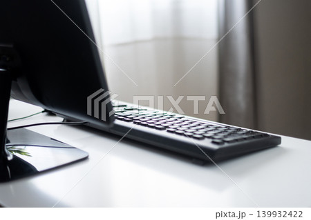 Minimal Computer Workspace with Keyboard and Monitor on White Desk Minimal Computer Workspace with Keyboard and Monitor on White Desk 139932422