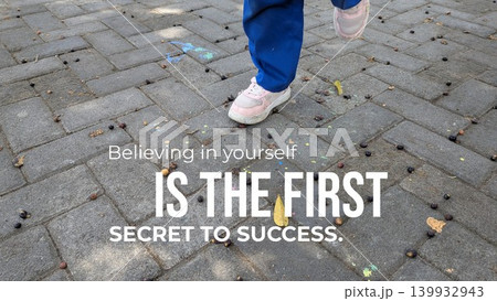 A graphic featuring an inspirational quote on a paved outdoor surface with an image of someone's legs and feet. The text says "Believing in yourself IS THE FIRST SECRET TO SUCCESS." A graphic featuring an inspirational quote on a paved outdoor surface with an image of someone's legs and feet. The text says "Believing in yourself IS THE FIRST SECRET TO SUCCESS." 139932943