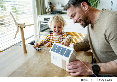 Father educating toddler about solar power and eco friendly living. Father educating toddler about solar power and eco friendly living. 139933831