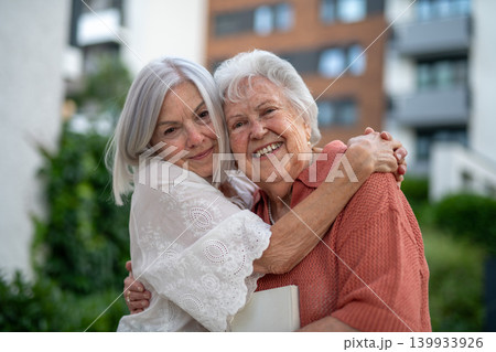 Portrait of beautiful adult daughter with old mother. 139933926
