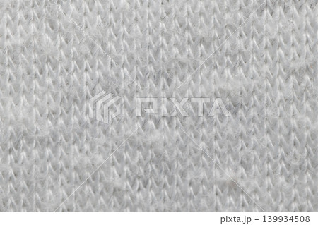 White knitted fabric texture macro warm wool clothing background White knitted fabric texture macro warm wool clothing background 139934508