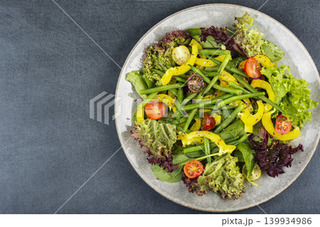 Green salad featuring fresh lettuce, tomatoes, bell pepper Green salad featuring fresh lettuce, tomatoes, bell pepper 139934986