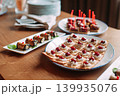 Assorted canapes and finger foods on trays for a holiday buffet 139935076