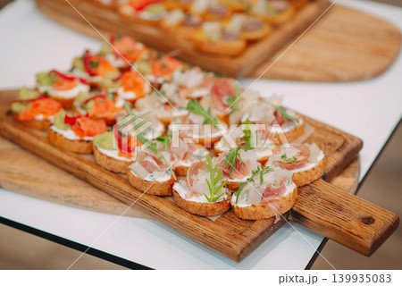 Canape on wood tray , pasty , bakery , fresh. Concept of catering at the event Canape on wood tray , pasty , bakery , fresh. Concept of catering at the event 139935083