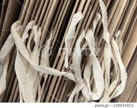 Layers of textured paper and strings create a captivating visual tapestry Layers of textured paper and strings create a captivating visual tapestry 139935852