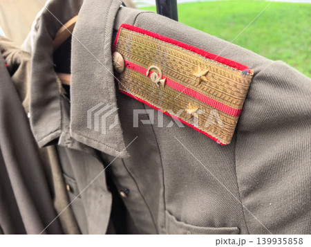 Vintage Soviet military uniform displaying historical insignia and craftsmanship Vintage Soviet military uniform displaying historical insignia and craftsmanship 139935858