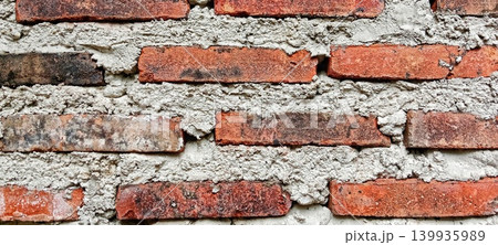Rough red brick and cement wall texture Rough red brick and cement wall texture 139935989