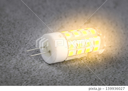 a led light bulb on a concrete background. 139936027